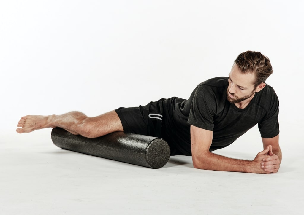 man massaging and stretching adductors with best foam roller moves