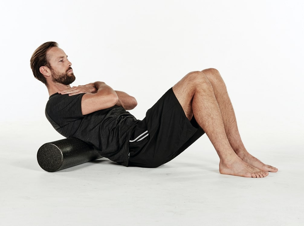 man massaging back muscles with best foam roller moves