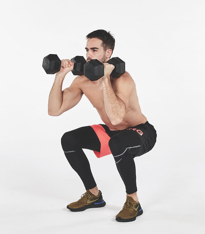 topless man demonstrates how to perform dumbbell thruster exercise