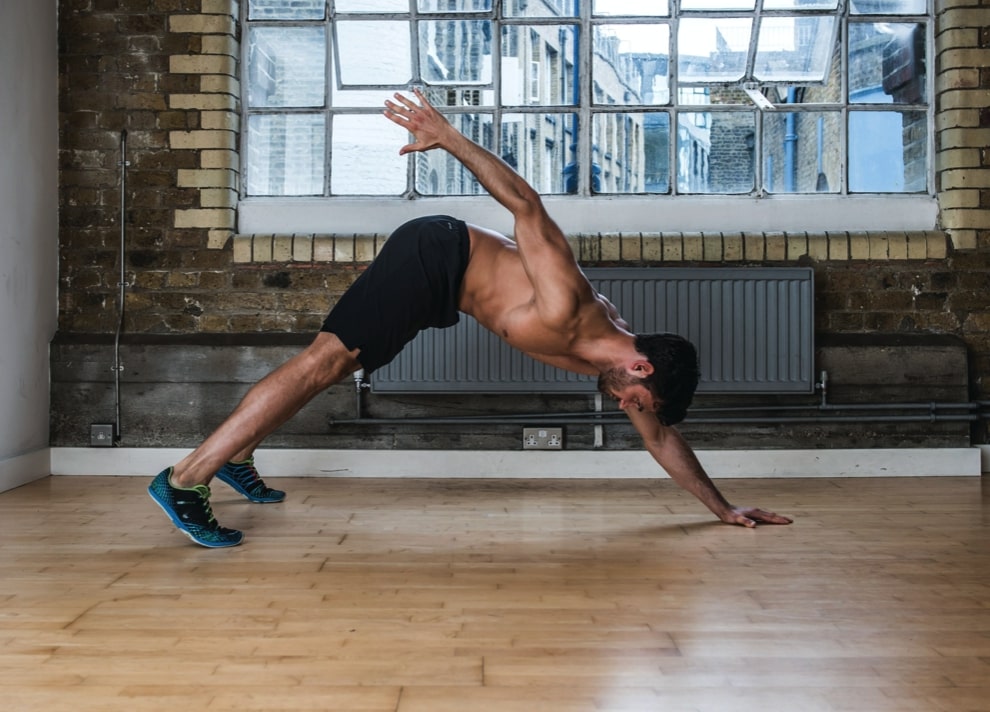 Man performing second part of three-point reach variation