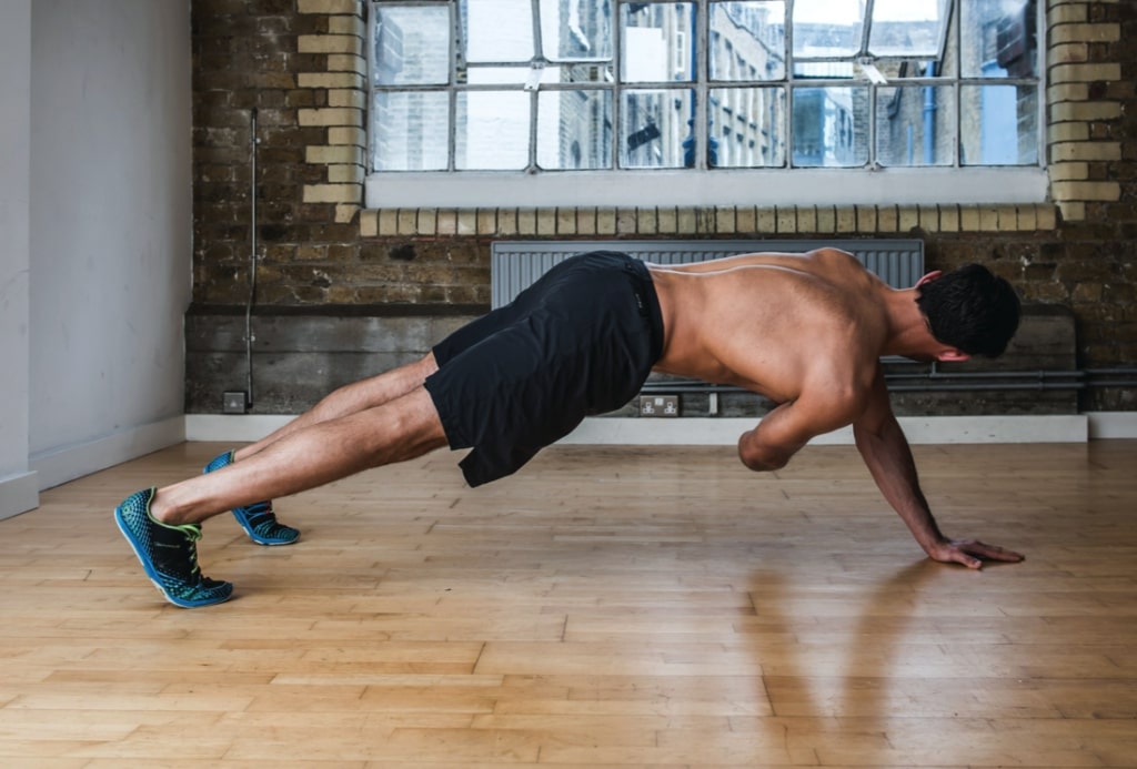 Man performing second part of side roll twist abs exercise