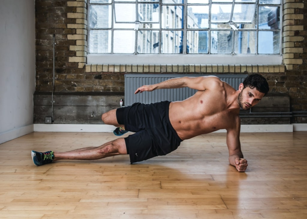 Man performing second part of side heel tap abs exercise