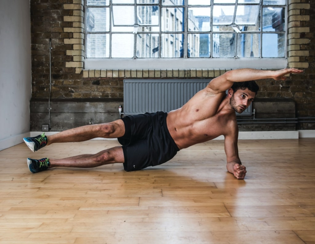 Man performing side heel tap abs exercise