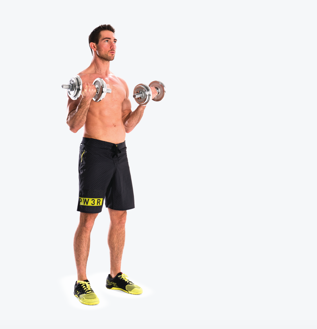 man demonstrated standing curl in dumbbell arm and shoulder workout; standing tall, he holds two dumbbells and repeatedly lifts and lowers them, keeping his elbows tucked in