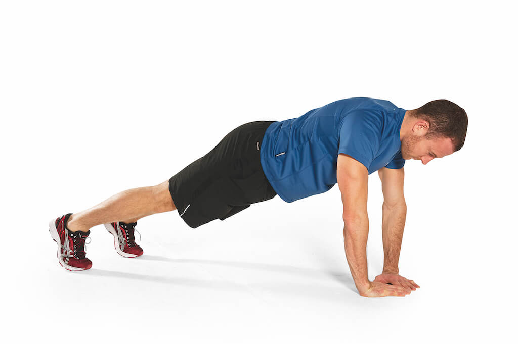 man in blue t-shirt and black shorts performing diamond press-up to build bigger arms