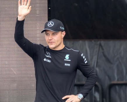 F1 driver Valterri Bottas waving to fans