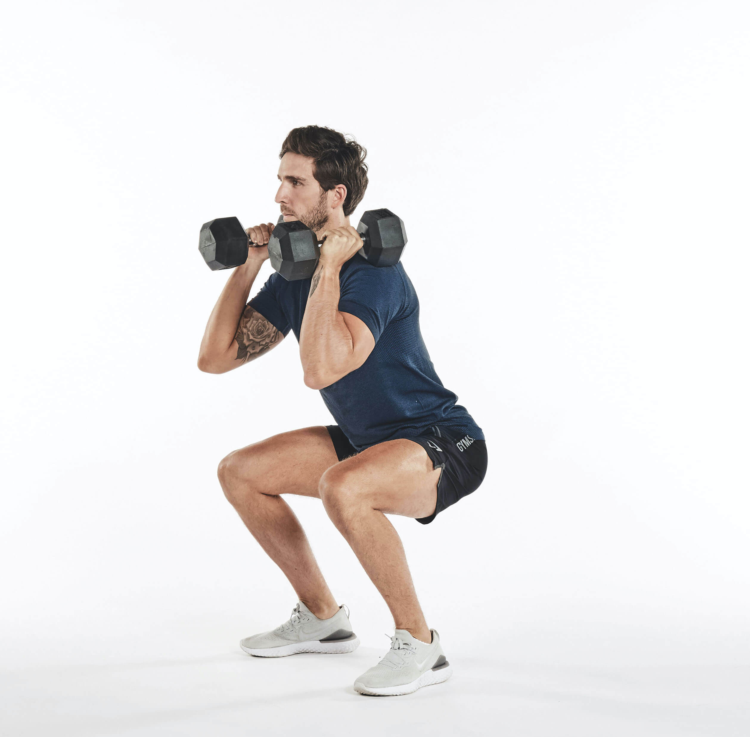 PT performing dumbbell thruster as part of a 15-minute dumbbell workout