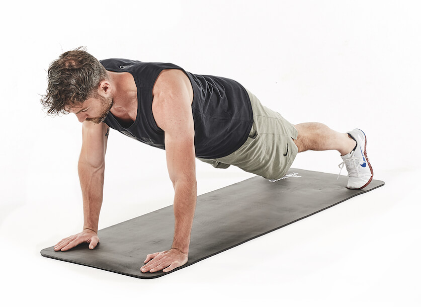 man demonstrates plank shoulder taps in 30-minute fat loss workout