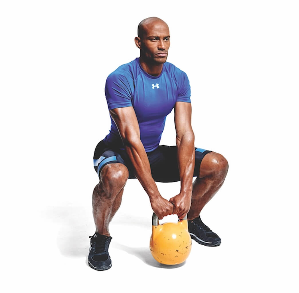 man performing kettlebell sumo squat as part of a workout for cyclists
