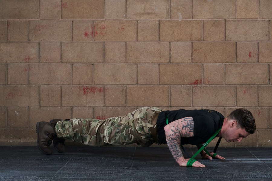 Man demonstrating a press up in Full Body Resistance Band Warm Up Routine