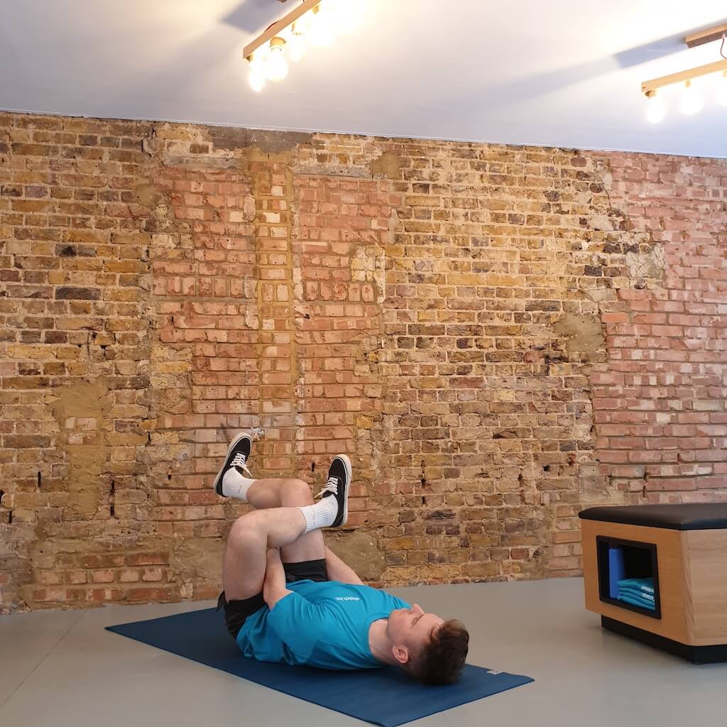 Man performing stretching exercises on his back