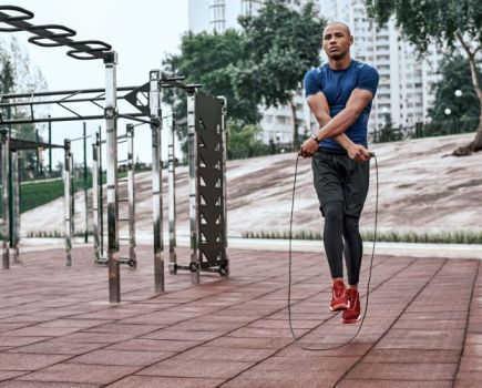 A man exercising in an outdoor gym