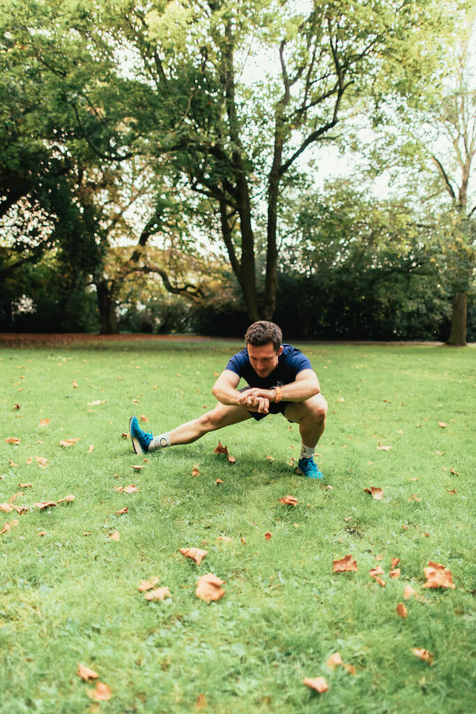 man demonstrates side lunge in in bodyweight workout for runners