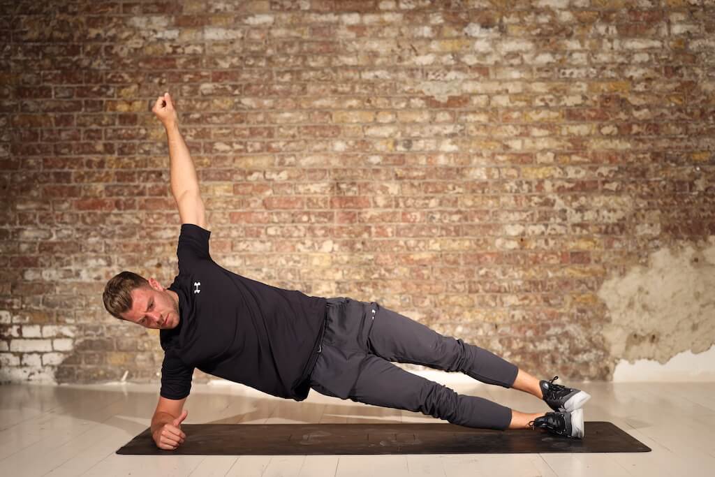 man demonstrates side plank in bodyweight abs workout