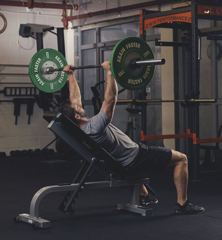 Man demonstrating a Barbell Incline Bench Press