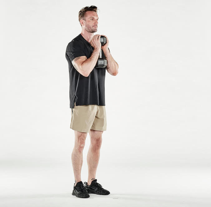 man performs forward lunge with dumbbell