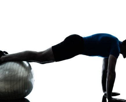 man performing one of the best exercise ball exercises