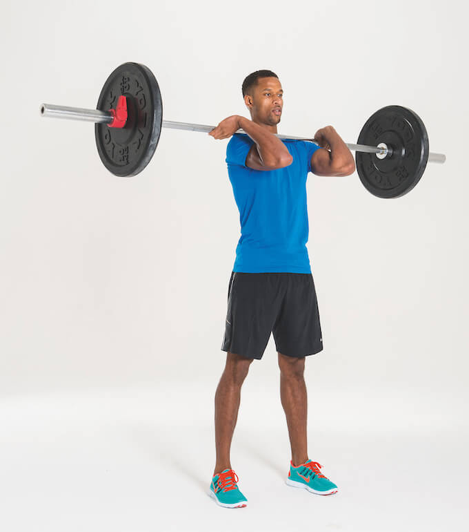 man performing barbell hang clean as part of Men's Fitness cover model workout plan