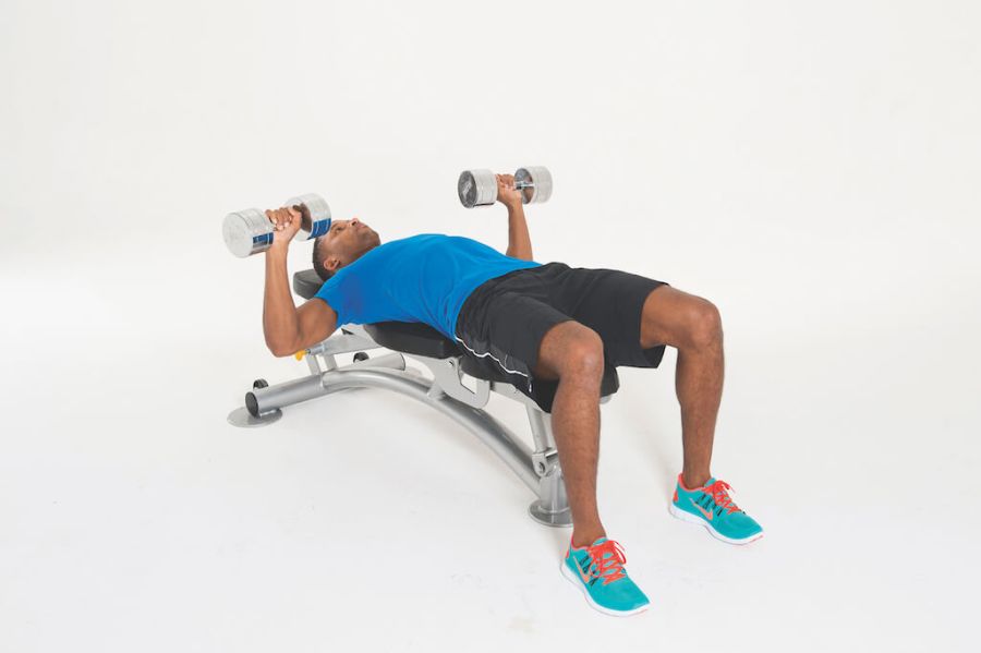 man performing dumbbell chest press