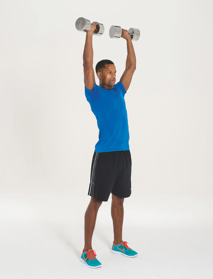 man performing standing dumbbell overhead press