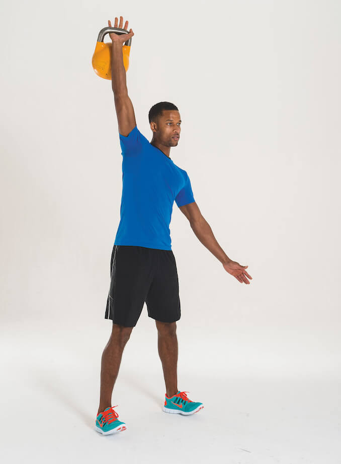 man performing kettlebell clean and press