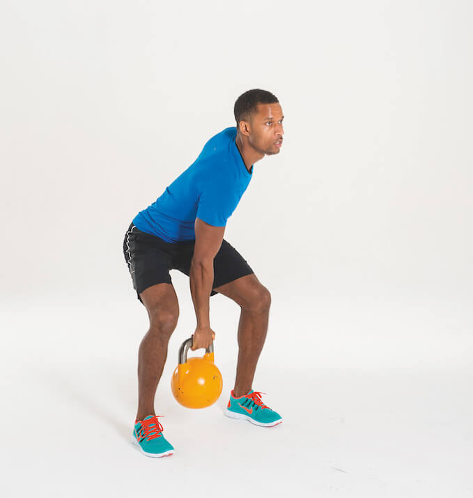 man performing kettlebell clean and press