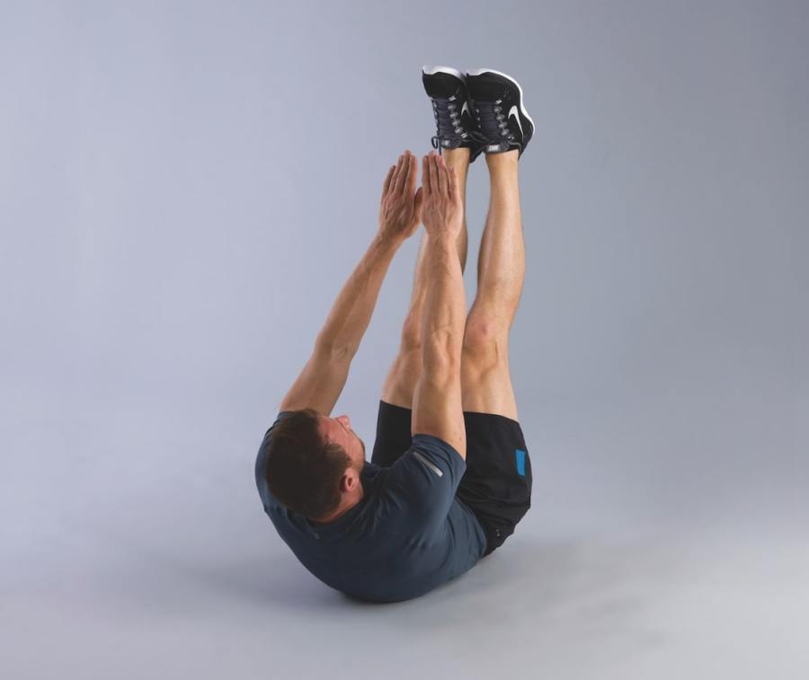 man performing v-up abs exercise