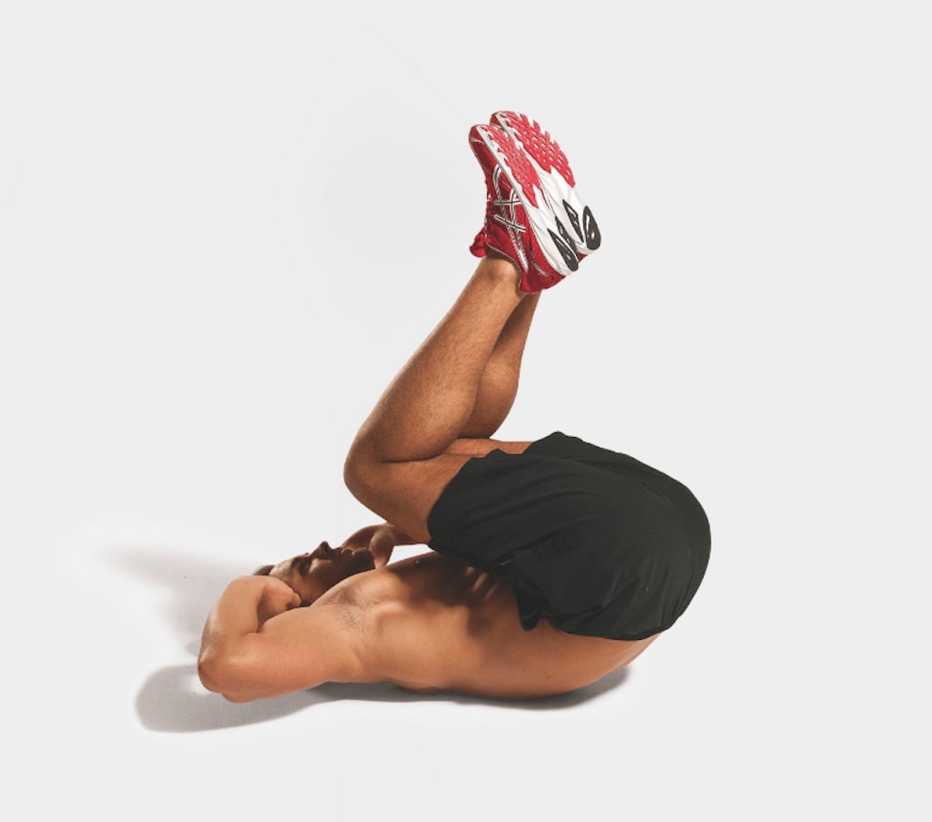 man demonstrating reverse crunch best abs exercises