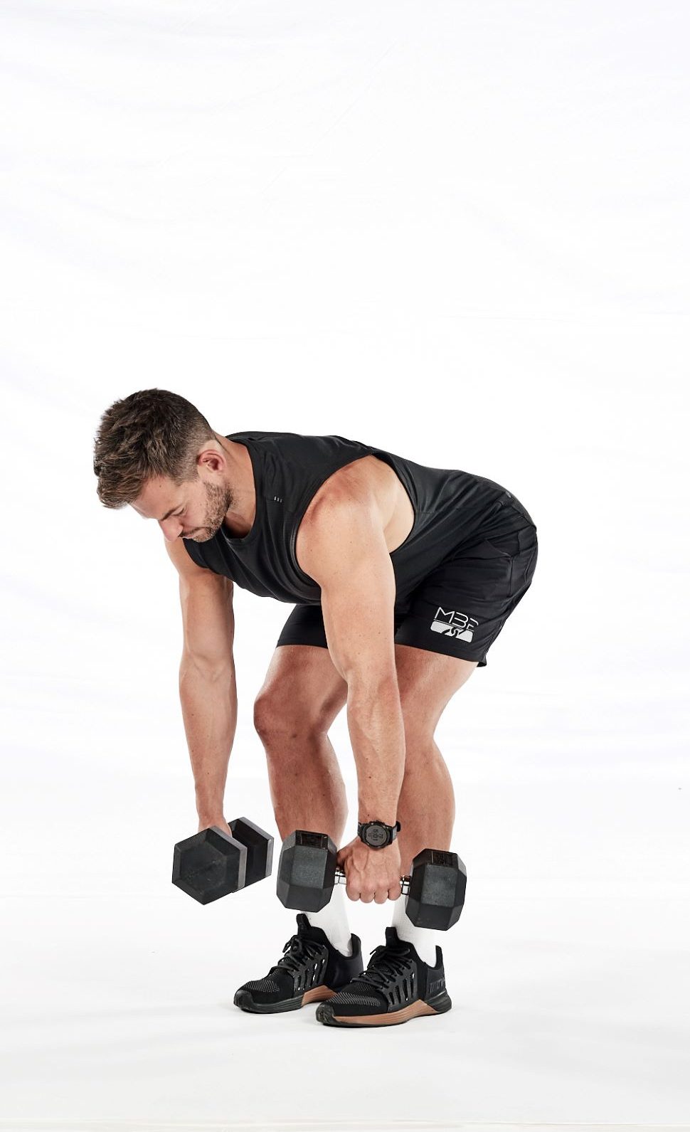 Two stages of the dumbbell bent-over row – holding dumbbells with bent knees, leaning forward from the hips, with weights hanging at knee level; then still leaning forward with weights pulled up towards lower sternum