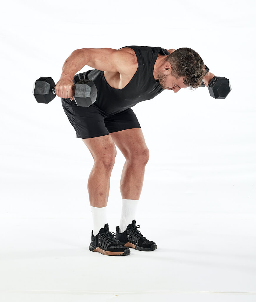 Two stages of the dumbbell reverse flye – holding dumbbells hanging straight down, feet shoulder-width apart and bent forward at the hips; in the same position with arms raised out towards the sides.