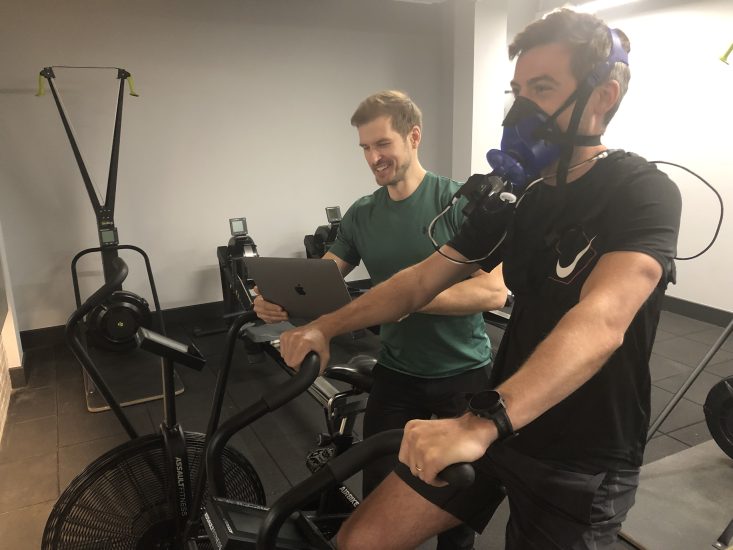Man wearing a mask, riding an exercise bike, undergoing metabolic testing