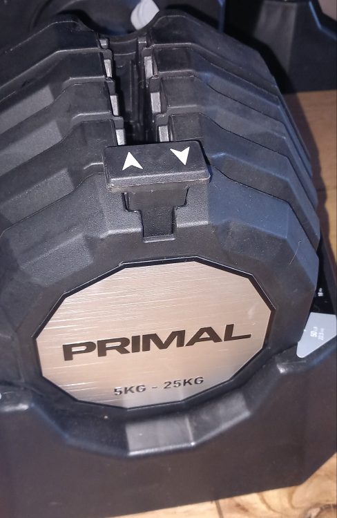 Primal Strength adjustable dumbbell on wooden floor