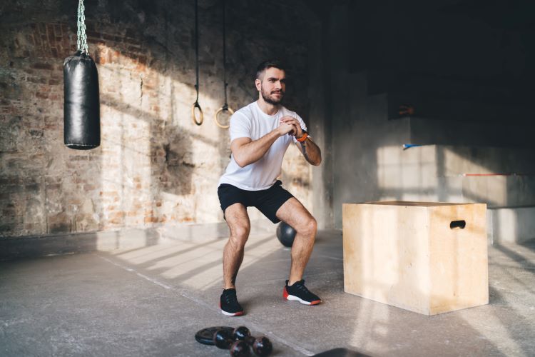 Man using bodyweight exercises in gym