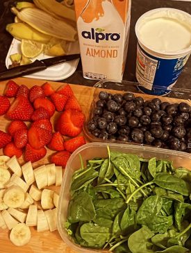 Portions of fresh fruit, yoghurt and spinach
