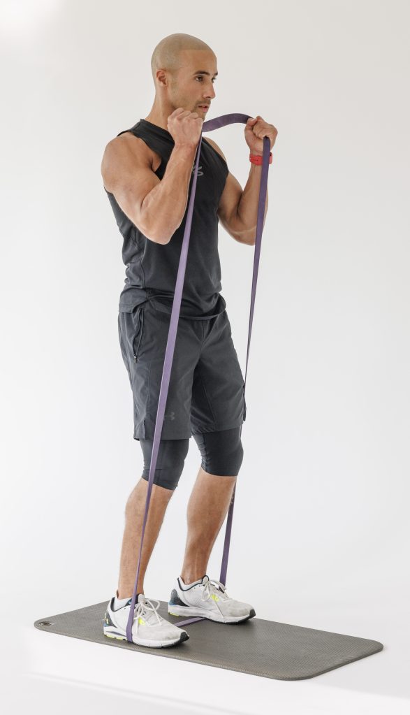 Man performing banded bicep curl  in resistance band full-body workout