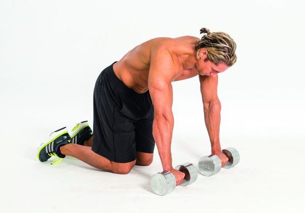 Man performing a dumbbell rollout