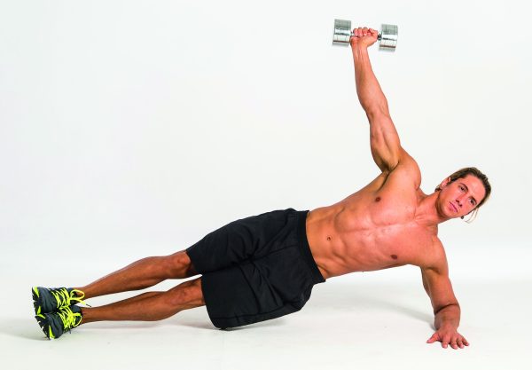 Man performing dumbbell plank snatch