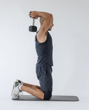 Man performing start of overhead tricep extension