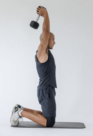 Man performing end of overhead tricep extension