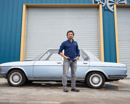 Richard Hammond stands in front of a vintage car with hands in pockets