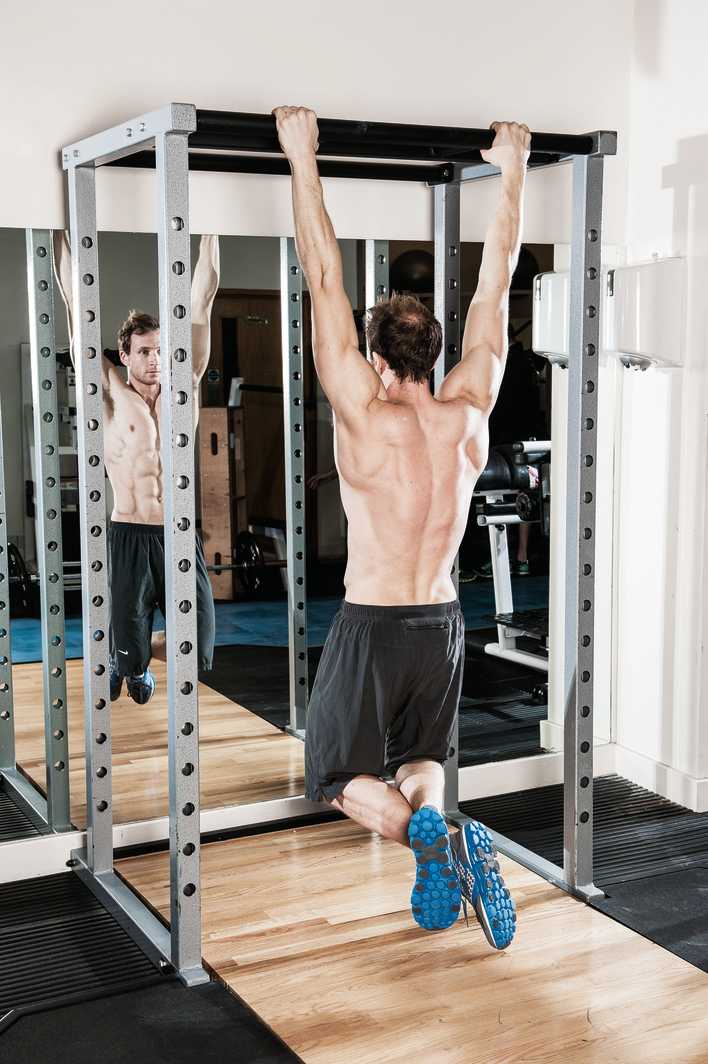 man demonstrates pull ups to build back muscles