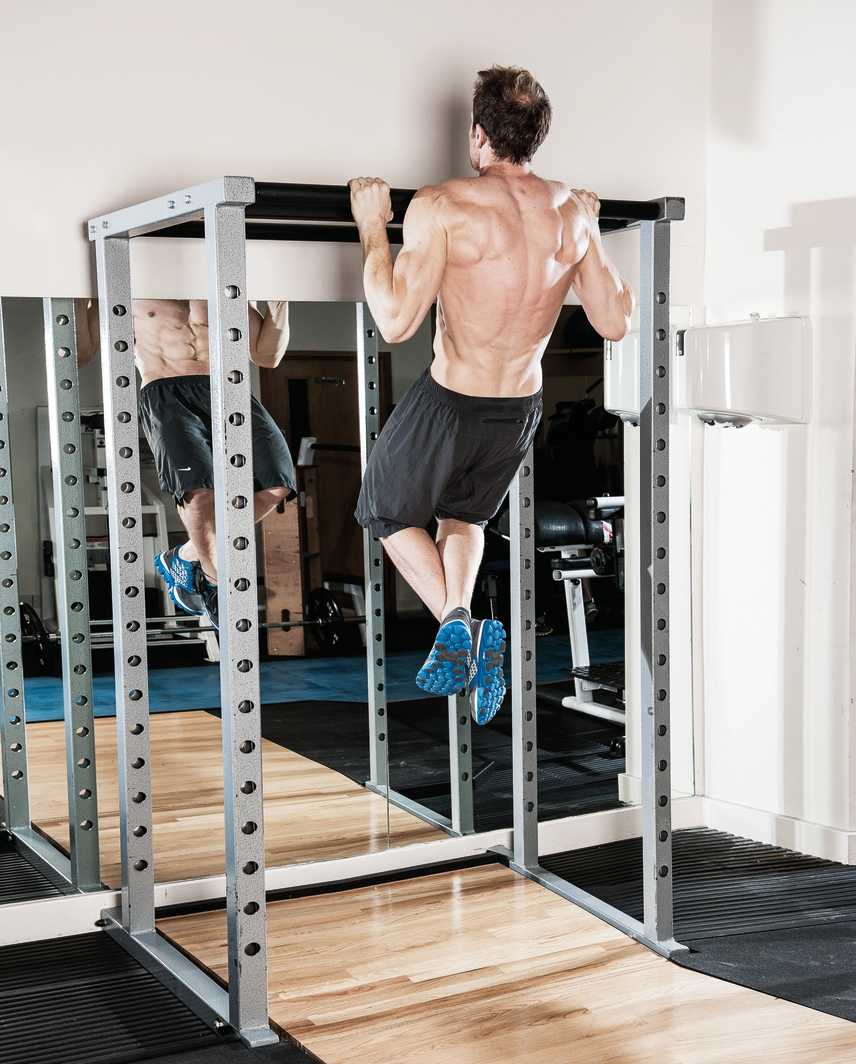man demonstrates how to do a pull up, one of the best exercises to build back muscles