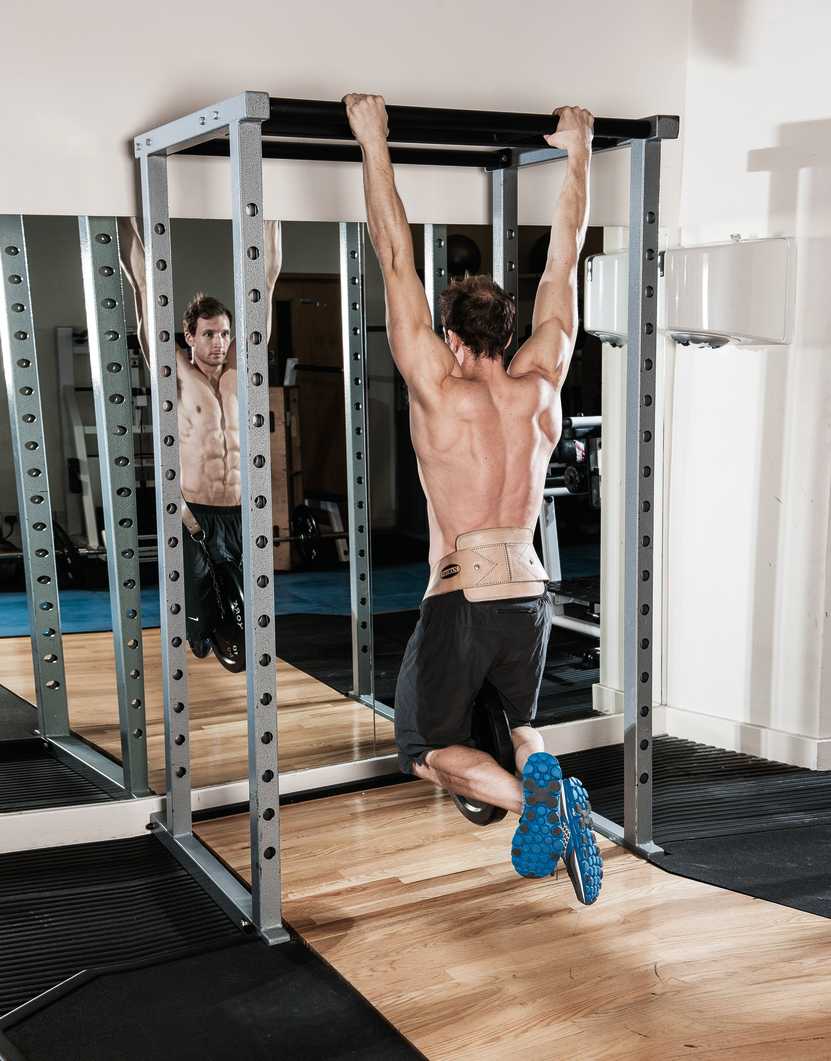 man demonstrates how to build back muscles with weighted pull ups
