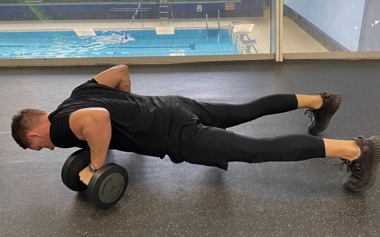 Man performing stabilising press-up - dumbbell chest workout