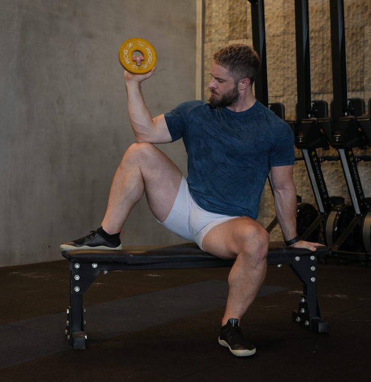 Man performing end of seated external rotation - best rotator cuff exercises