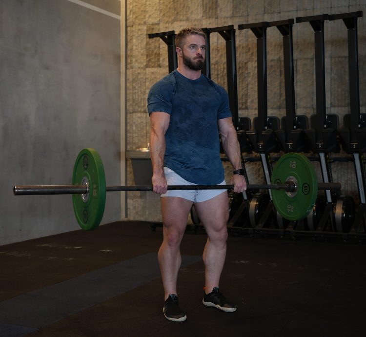 Man performing end of barbell exercise
