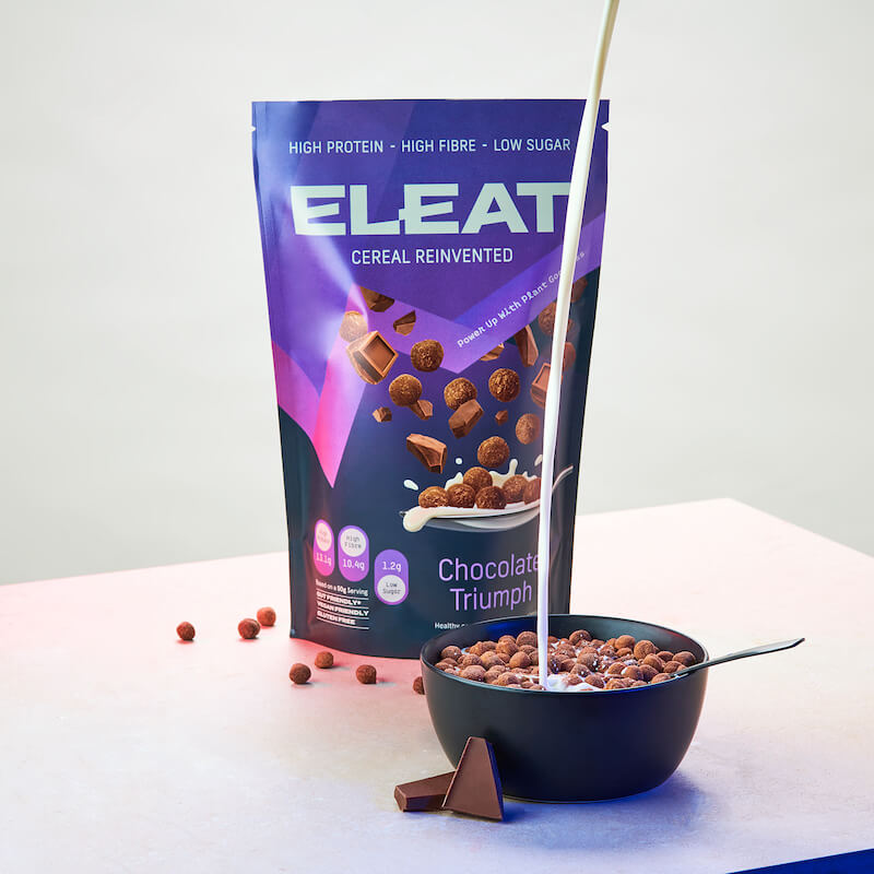Best protein cereal brands UK: ELEAT chocolate cereal in bowl, with packaging in background