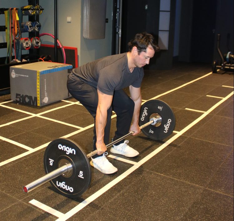 Man performing a conventional deadlift - 