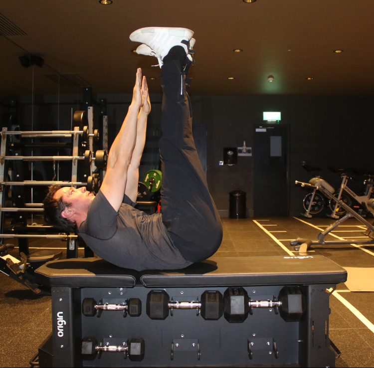 Man performing end of a V-sit exercise