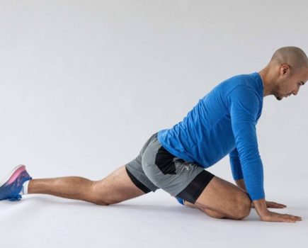 Man performing end of a pigeon stretch - best hip stretches